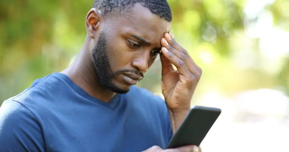 Concerned man checks political news on his phone
