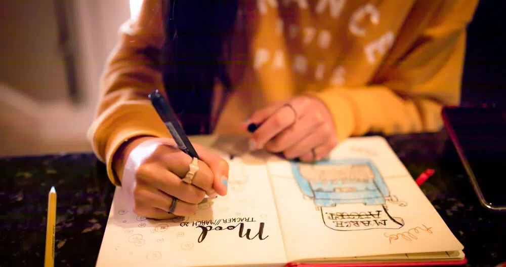 Woman writes in mood tracking journal