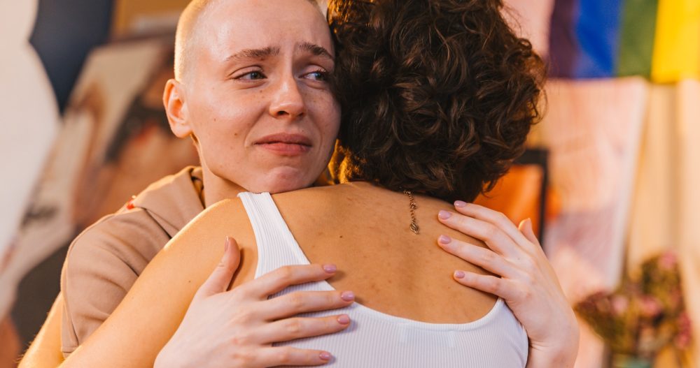 Person crying during hug