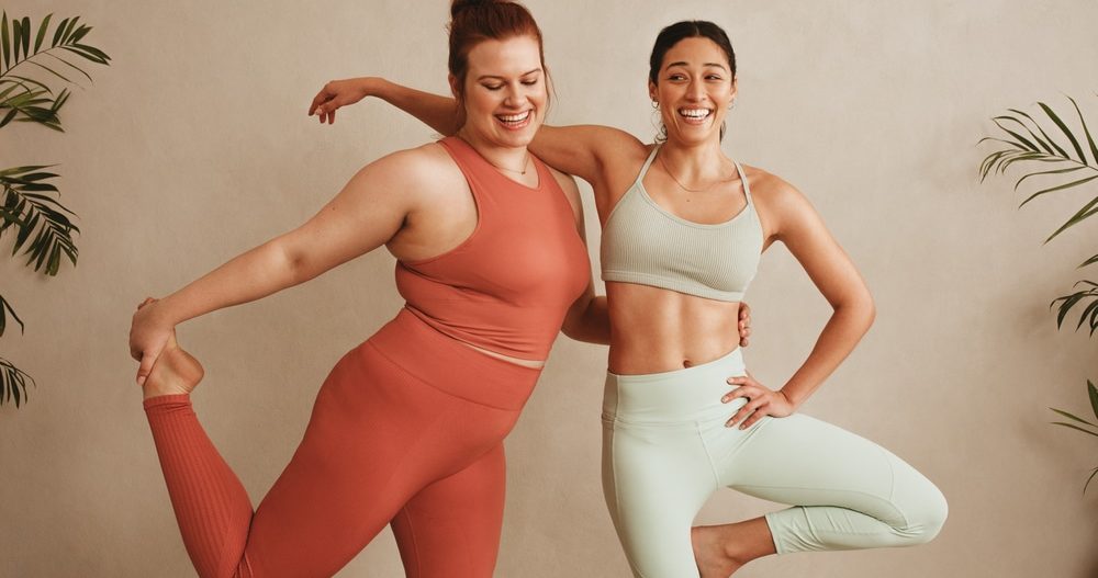 Two women standing together in sportswear who no longer hate their body