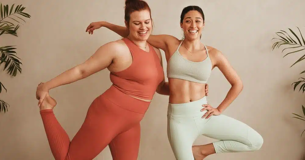 Two women standing together in sportswear who no longer hate their body