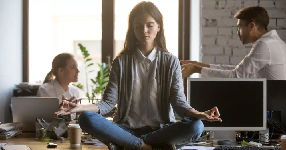 a woman sitting on a table meditating