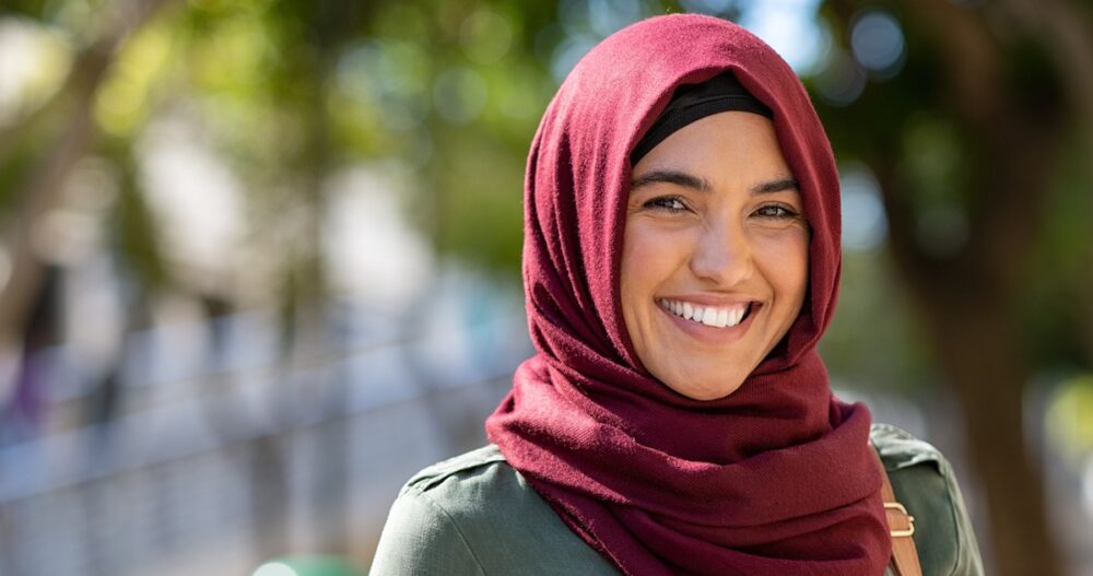 Woman wearing a hijab smiling outdoors