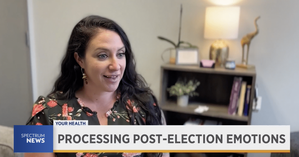 Woman with dark hair being interviewed by the local news on how to deal with post election emotions