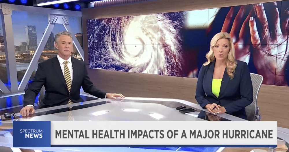 Two news anchors discussing the impacts of recent hurricanes in Fliroda on mental health