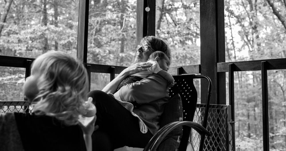 woman caring for two young kids