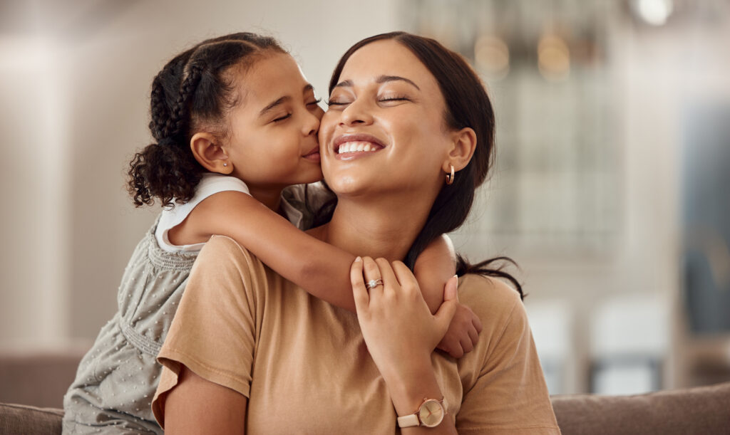 Mom and daughter hugging and smiling