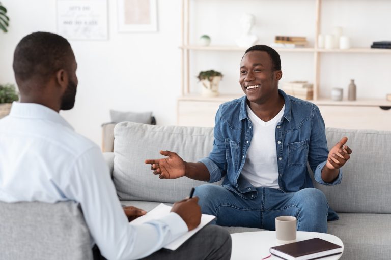 two men sitting and talking during psychedelic therapy