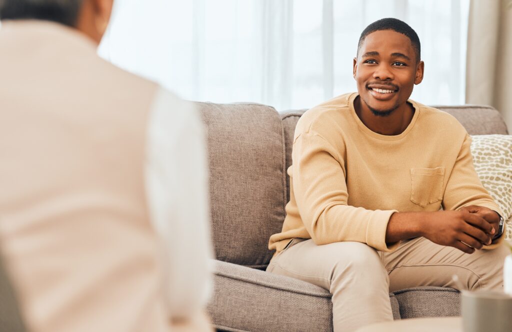 Man sitting on a couch during a therapy session
