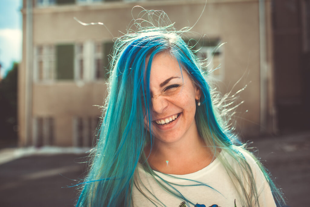 Girl with blue hair making a funny face