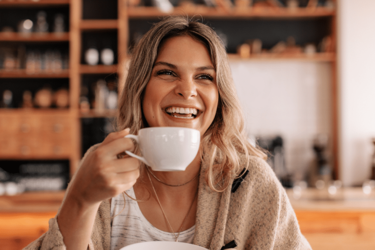 Portrait of a young woman sitting in a coffee shop drinking coffee