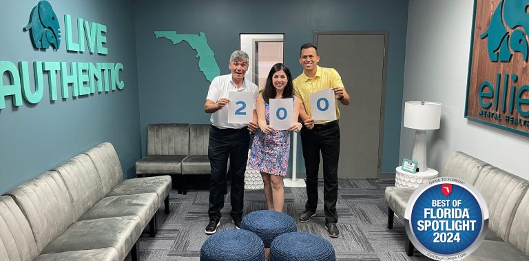 Ellie Mental Health Lake Worth, FL Franchisees receiving a Best of Florida award. The franchisees are standing with an official representative and holding signs that show the number 200