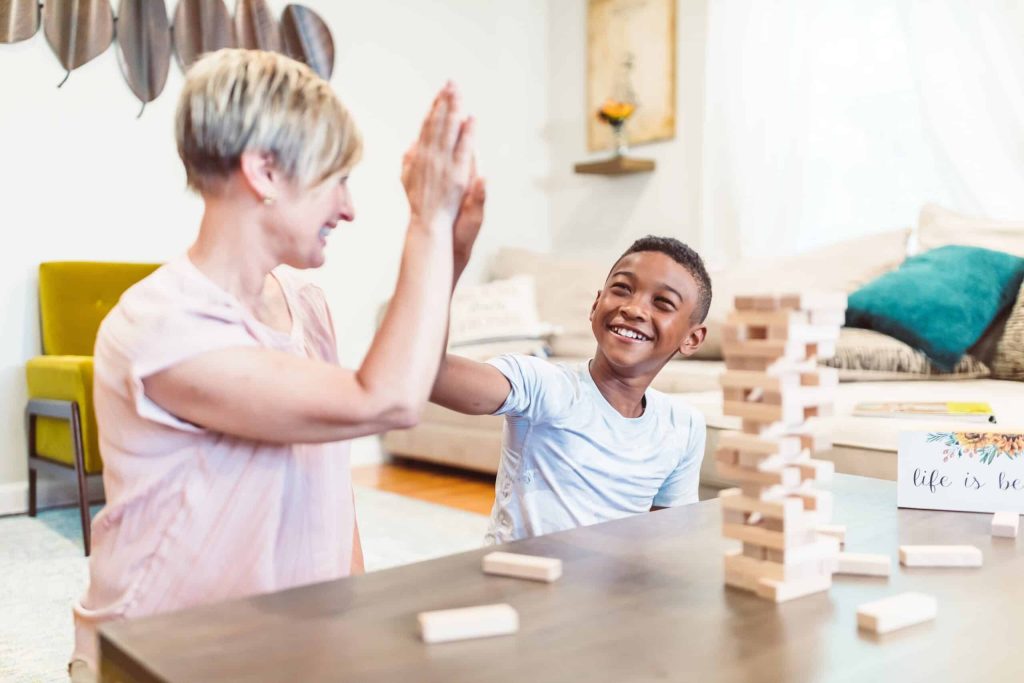 Woman High fiving a boy while playing Jenga