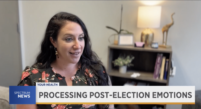 Woman with dark hair being interviewed by the local news on how to deal with post election emotions