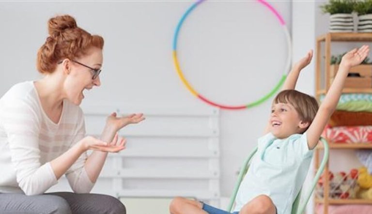 Mom and her child sitting smiling at each other