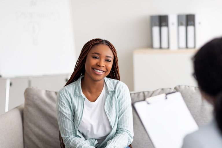 Young female client having consultation with psychologist
