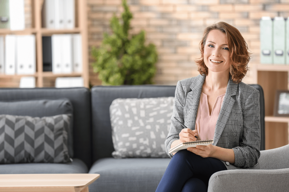 Woman sitting on a therapy couch smiling