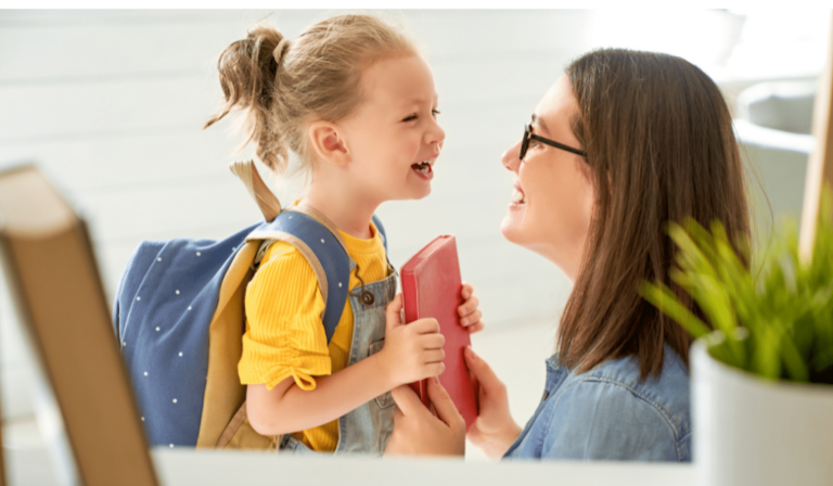 woman and her daughter looking at each other and smiling while the daughter gets ready to leave for school.