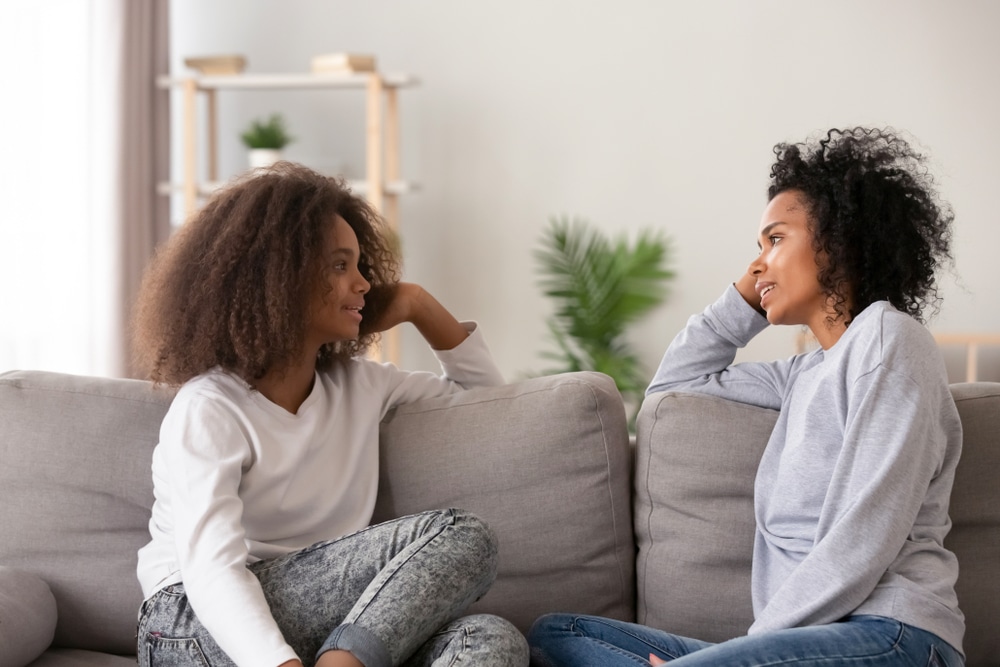 Teenage girl talking to her parent about mental health