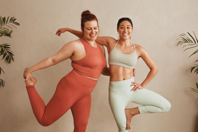 Two women standing together in sportswear who no longer hate their body