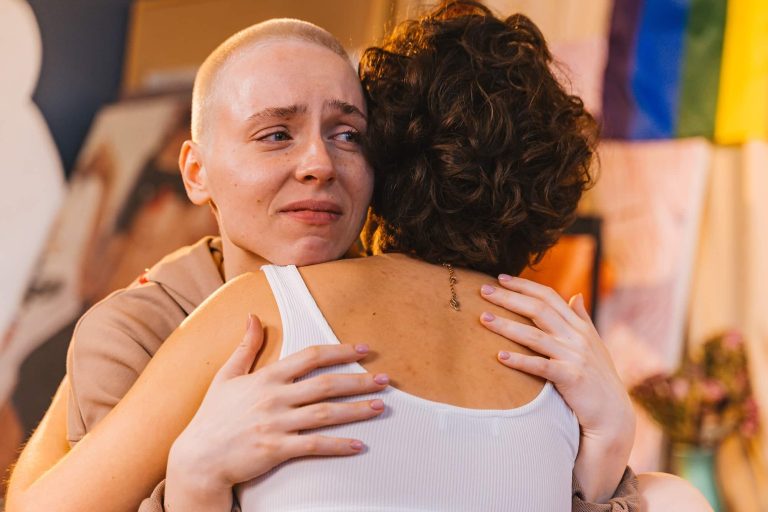 Person crying during hug