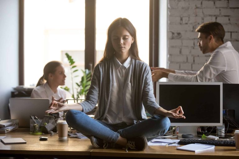 a woman sitting on a table meditating