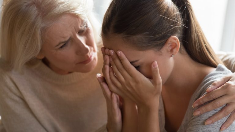 Loving Elderly 60 year old mom Embraces Crying Hurt Adult Offspring