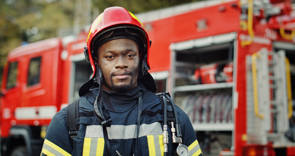 Firefighter standing in front of a fire truck