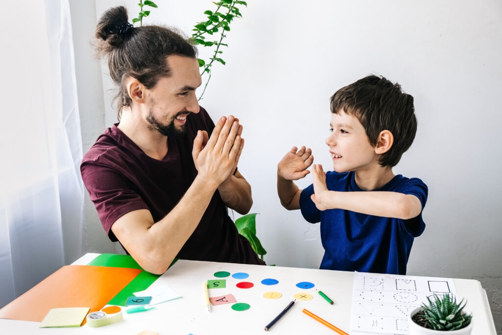 Boy and his data high fiving and coloring