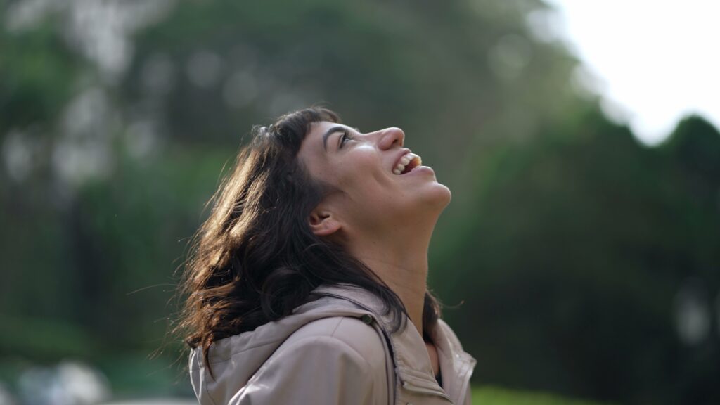 Happy woman staring at the sky smiling