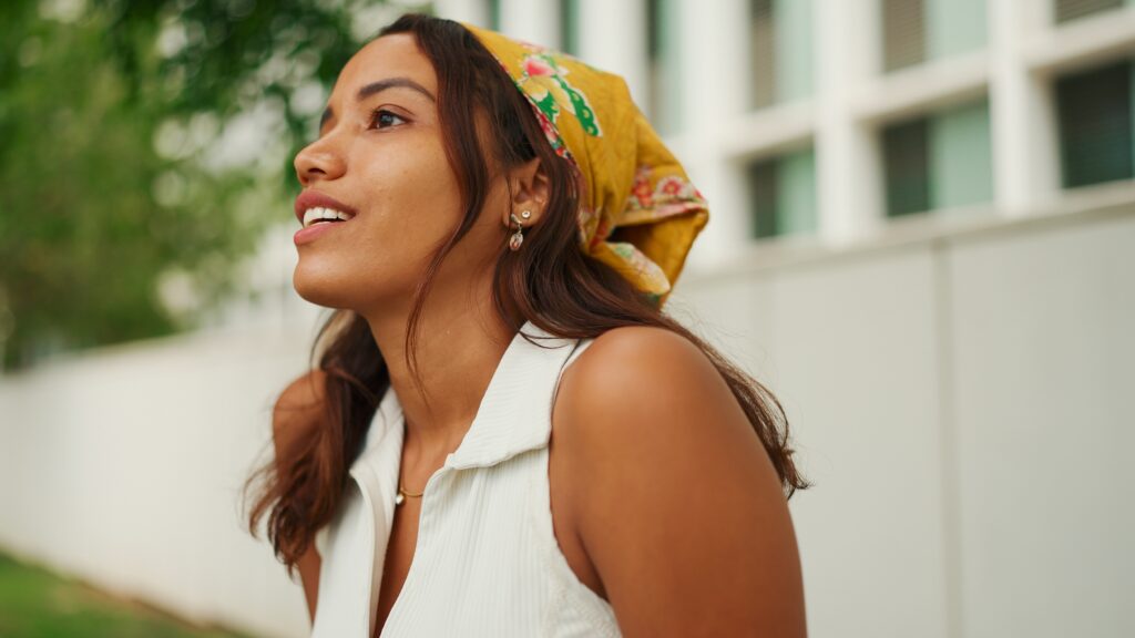 Young woman wearing a bandana looking into the distance