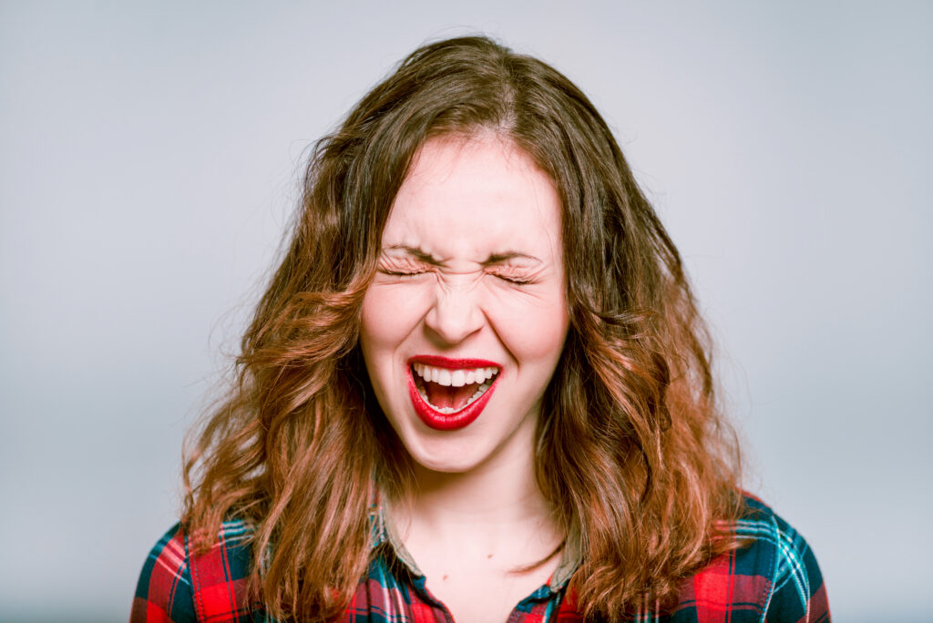 Portrait of a young woman exults and screams