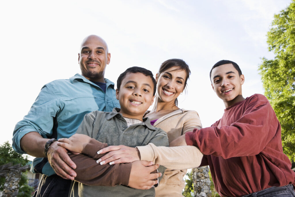 Family standing outside smiling for the camera
