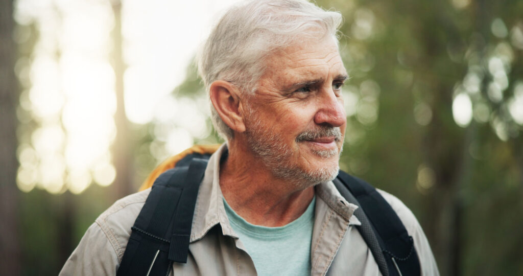 Calm man with gray hair hiking